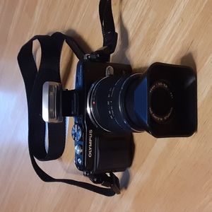 Olympus E-PL5 with original manual, setup CD, charger with cable, and more.